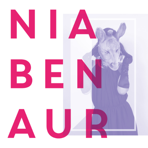 Promotional image for Nia Ben Aur concert, 2024 Eisteddfod: woman weraing pig's head on a pink background