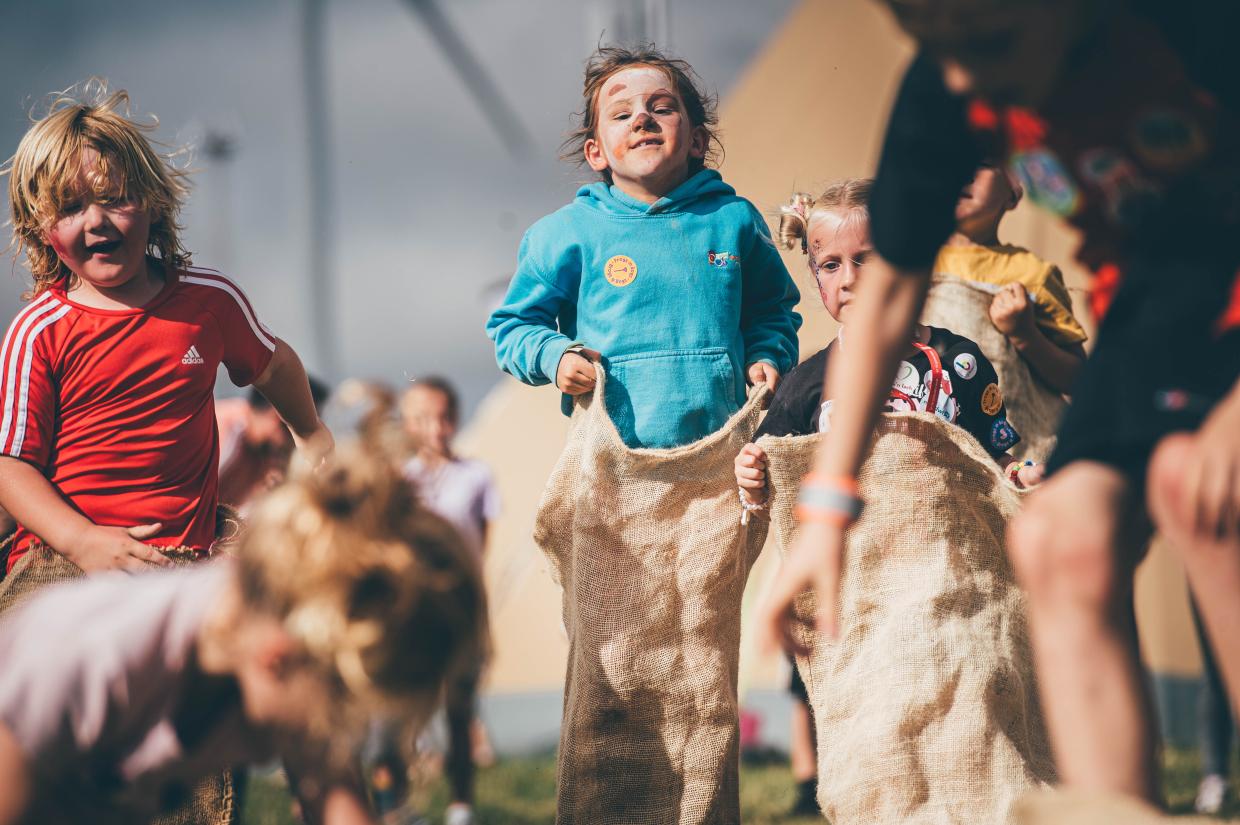 Children sack race in children's village at Eisteddfod