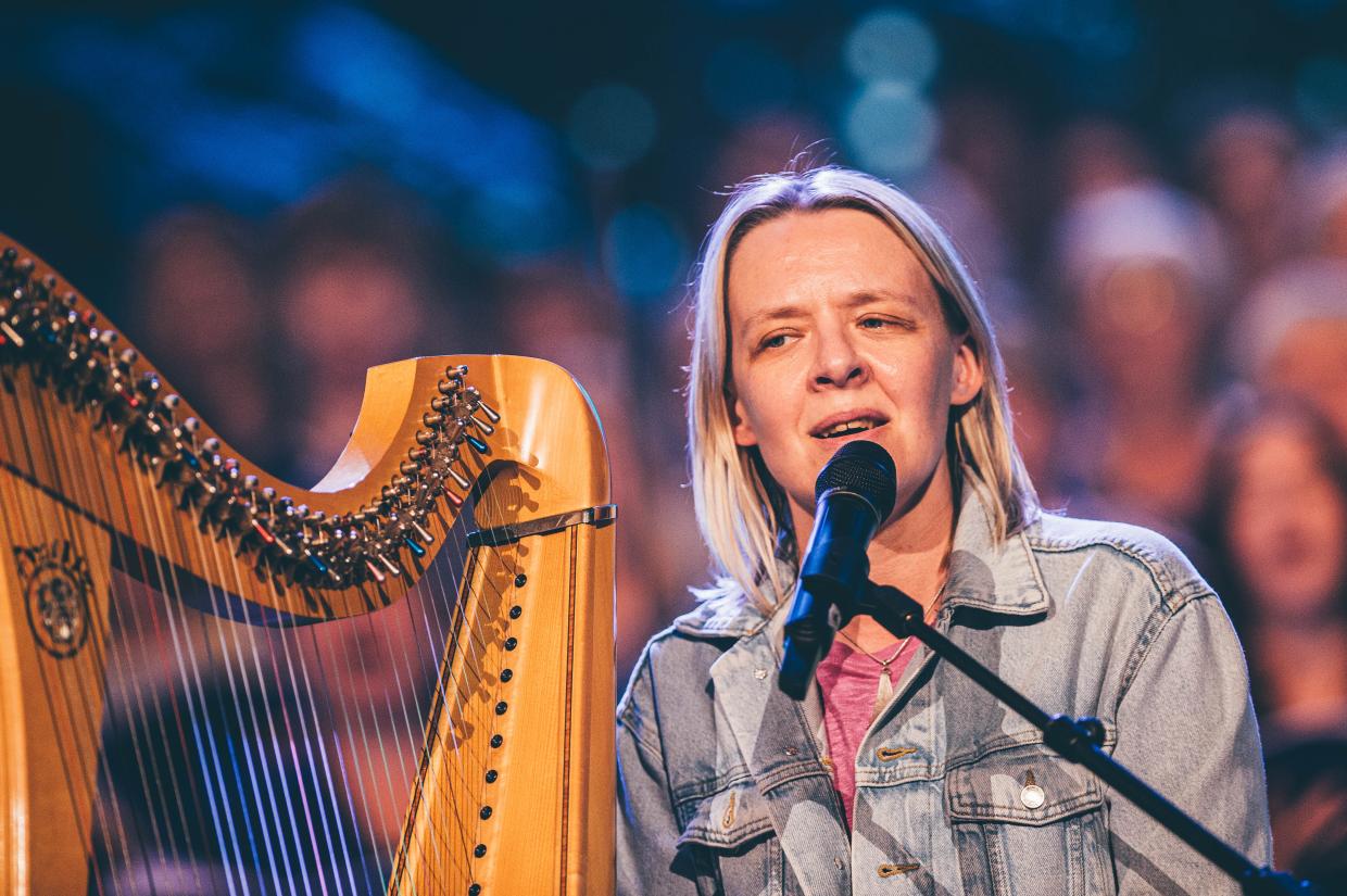 Woman playing harp on pavilion stage