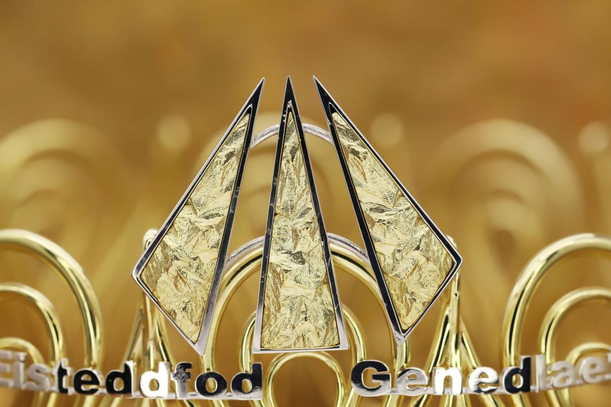 The Nod Cyfrin, the Gorsedd Cymru symbol, is displayed prominently against a softly blurred background. The base of the image partially reveals the words 'Eisteddfod Genedlaethol'.