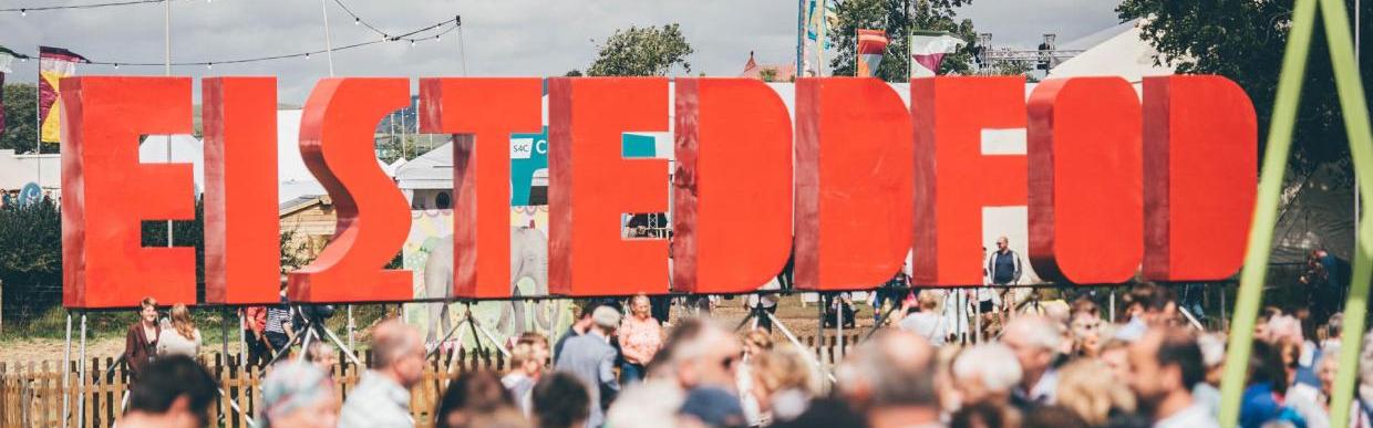 Eisteddfod sign with people in front of it