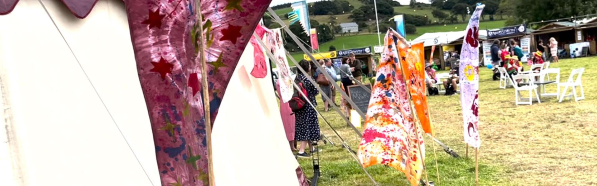 flags and stands in a field with a few people in the picture